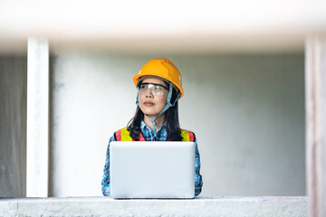 Construction site analysis female engineer using laptop urban environment professional perspective technology engagement