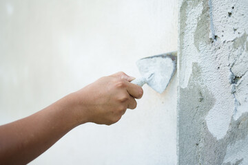 Applying plaster to wall home renovation site construction process indoor environment close-up view...