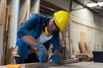 Black people, Carpenter and furniture workshop. African American male carpenter using tools for...