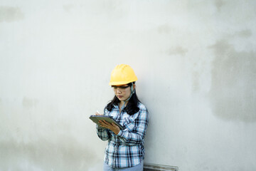 Construction site inspection engineer with clipboard urban environment professional action ground level industry focus