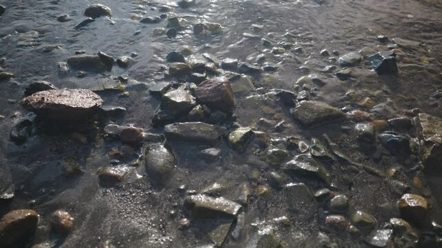 Small waves comes calmly into the beach on a sunny day