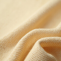 Soft Beige Knitted Fabric Texture with Natural Folds and Warm Lighting, Close-Up Textile Background