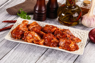 Raw marinated buffalo chicken wings