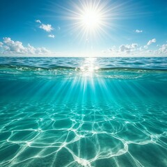 Crystal clear ocean water with sunlight rays and a bright blue sky