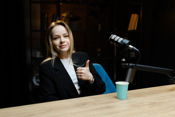 Smiling woman recording podcast in home studio