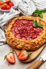 Delicious homemade strawberry galette with almond petals and fresh mint