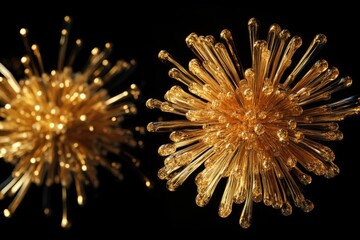Golden fireworks burst isolated on black background. Two fireworks explode in the air, one is a large gold firework and the other is a smaller one.