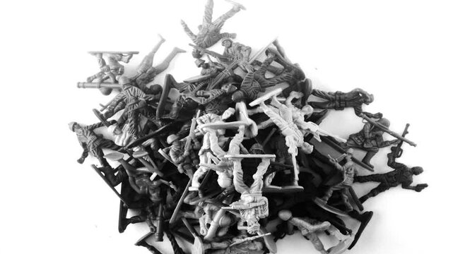 Toy soldiers pile up on a white background 