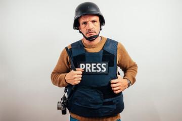 Reporter in bulletproof vest with a camera.