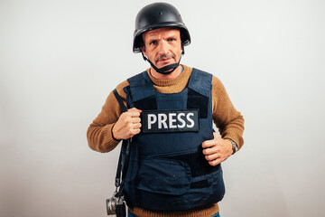 Reporter in bulletproof vest with a camera.