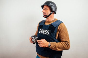 Reporter in bulletproof vest with a camera.