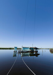 Old fishing scales on stilts in the quiet of the Tuscan swamp