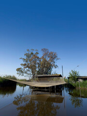 Old fishing scales on stilts in the quiet of the Tuscan swamp