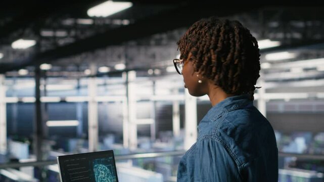 Data center coworkers doing maintenance on mainframes handling AI processing tasks. Server hub system administrators managing storage arrays supporting deep learning training workflows, camera B