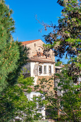Naklejka premium Historical house among natural frames in Sirince village, Izmir. Wooden and stone structure seen through the trees. Authentic architecture idea concept.