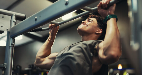 Fitness, man and exercise on pull up bar at gym for shoulder muscle, bicep strength or bodybuilding performance. Bodybuilder, energy and power training at sports club for intense workout or endurance