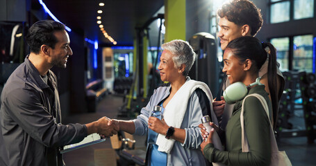 Man, woman and handshake with welcome at gym for class, registration and tablet with exercise group. Mature person, personal trainer and touchscreen for respect, app or introduction at fitness center
