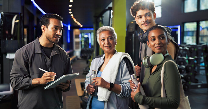 Personal trainer, talking and group with membership in gym, explaining and info for training routine. Wellness, instructor and man with tablet for digital sign up, online and benefits of health club - Powered by Adobe