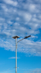 Street Light with Solar Panel Against Blue Sky