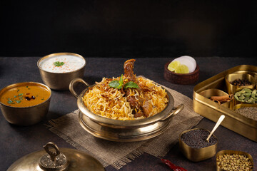 Authentic Hyderabadi Chicken Dum Biryani in a Traditional Brass Pot with Raita and Salan -...