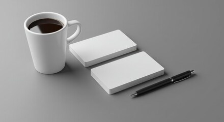 Business cards, coffee mug, and pen on a gray surface. Stacks of blank business cards, a coffee mug, and pen are arranged on a gray surface.