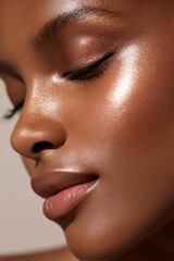 Glowing tan face with smooth skin and closed eyes showing natural beauty and shine in soft light