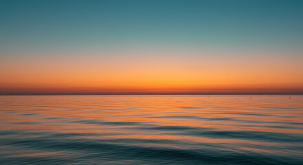 Obraz premium Serene Ocean Sunset Calm Waters Vibrant Orange and Teal Sky at Dawn