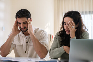 Couple overwhelmed by overdue bills and low income, facing economic stress and inflation-related financial crisis