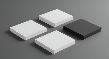 Stacks of blank white and black business cards arranged on a gray surface. Geometric design presentation of blank print media showcasing contrasting colors.
