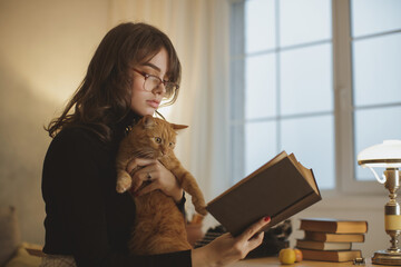 Young Woman Reading Book With Cat In Cozy Study Room 