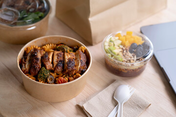 Close up paper bowl with healthy food on work place of working desk, Healthy eating clean food habits for diet and health care concept, Delicious balanced food concept.