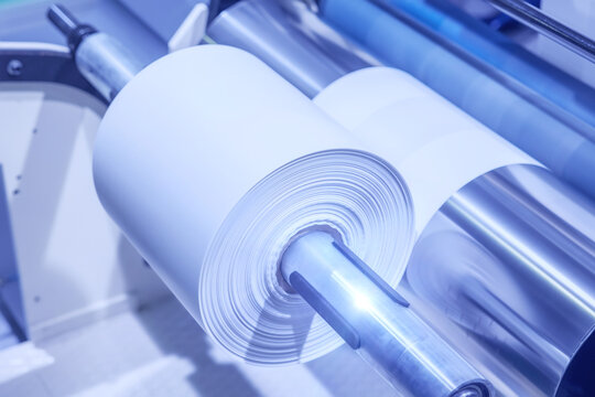 Roll of polyethylene film for bags and packaging. Extrusion line for the production of polyethylene film for products packaging. Winding a polyethylene roll for packaging