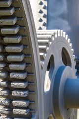 Detailed view of interlocking gears working together in a mechanical system during daylight