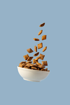 Levitating bowl with chocolate pads cereals nougats, breakfast