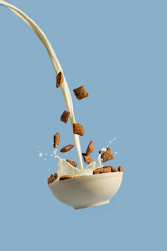 Levitating bowl with chocolate cereals nougats and milk