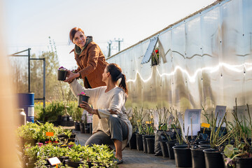 Two women working together at a garden center.