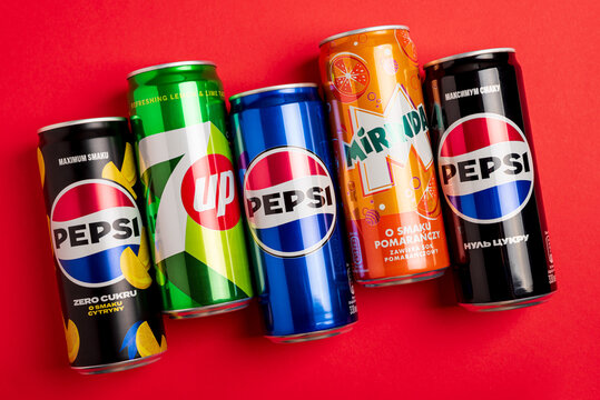 Lviv, Ukraine - May 25, 2025: Pepsi Zero Sugar Soda, Classic Soda, Zero Sugar Citrus Soda, 7up and Mirinda Cans on red background. Top view