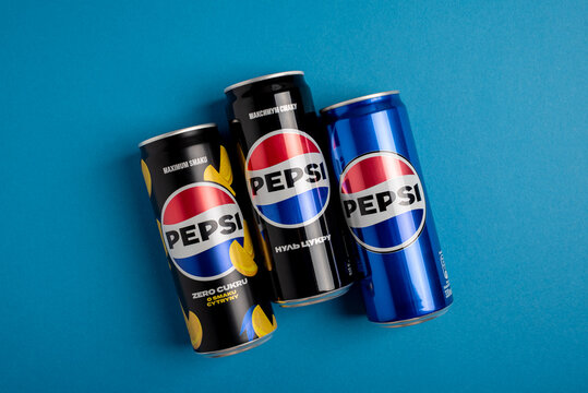 Lviv, Ukraine - May 25, 2025: Pepsi Zero Sugar Soda, Classic Soda and Zero Sugar Citrus Soda Cans on blue background. Top view