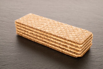 One sweet waffle, macro, on a slate stone.