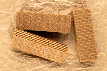 Three sweet waffles with, macro, on kraft paper, top view.