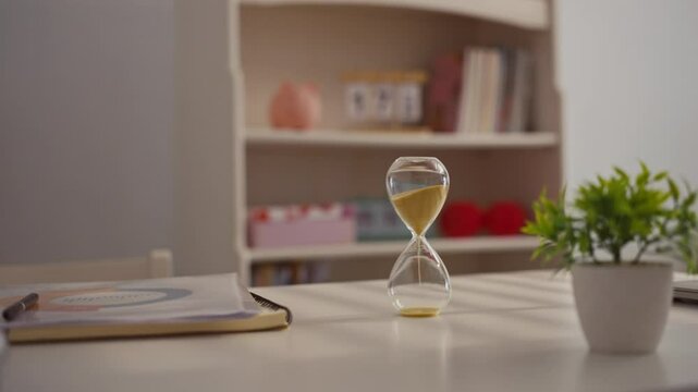 Close up hourglass on office table. Time management concept.