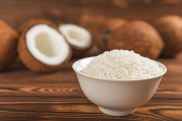 Set of fresh whole and half coconuts and slices on wooden background. Coconut flakes. Vegan. Tropical nut, fruit. Place for text. Copy space.