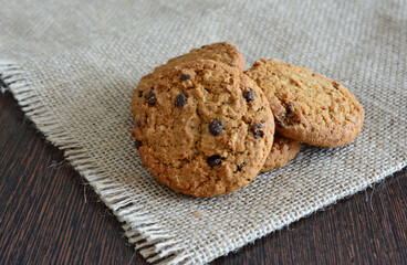 Close-up of delicious chocolate chip oatmeal cookies on a rustic wooden surface