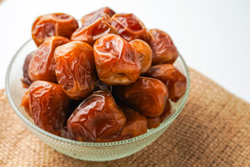 Dates fruit sukari or kurma sukari, in bowl isolated on white background