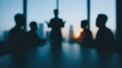 Silhouetted Business Meeting: A blurry image of businesspeople silhouetted against a city skyline during a meeting, symbolizing strategic planning and corporate collaboration.