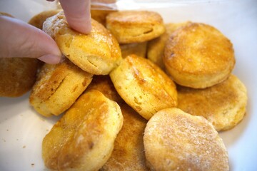 Potato patties in a bowl close up with hand
