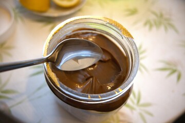 Peanut butter in a jar with spoon