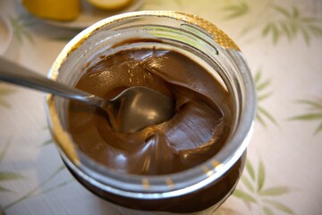 Peanut butter in a jar with spoon