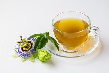 Cup of herbal tea with passiflora caerulea plant on white background. Alternative herb medicine,...