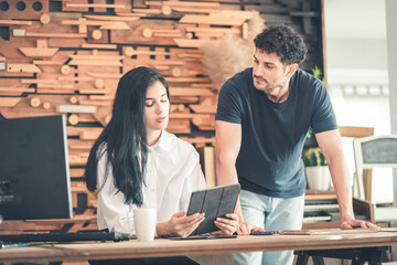 Small business owners partnership or colleagues in casual business attire discuss strategy using...